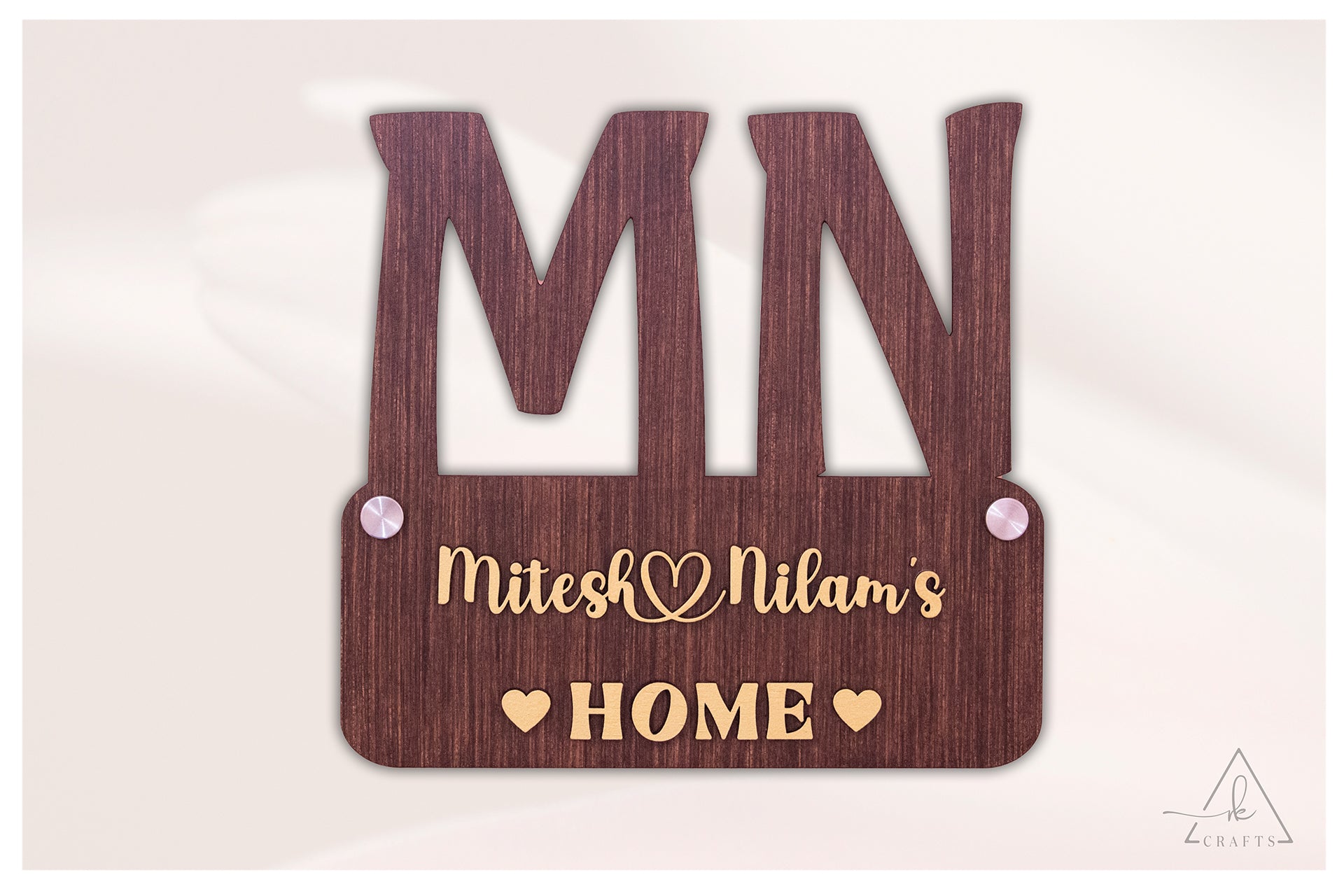 Brightly lit front view of a custom 3D wooden monogram couple name home sign.