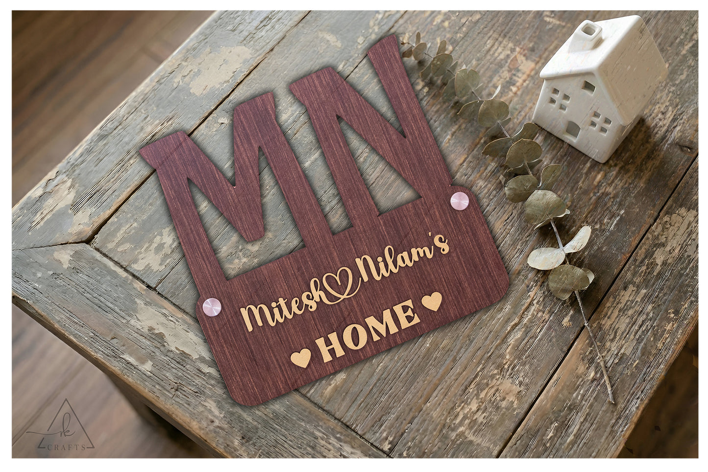 Detailed view of the dimensional 3D monogram and couple names on a rustic wooden wall sign.