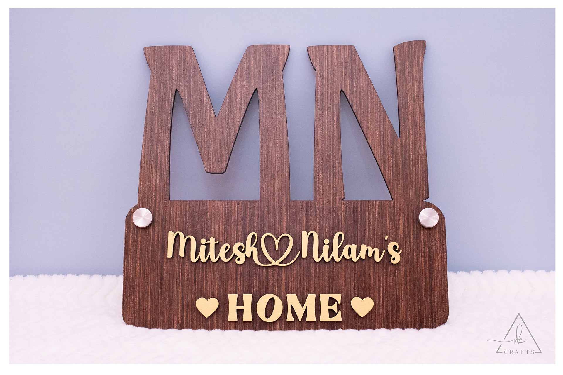 High-quality, bright display of a custom couple name home decor sign showing clear wood grain.