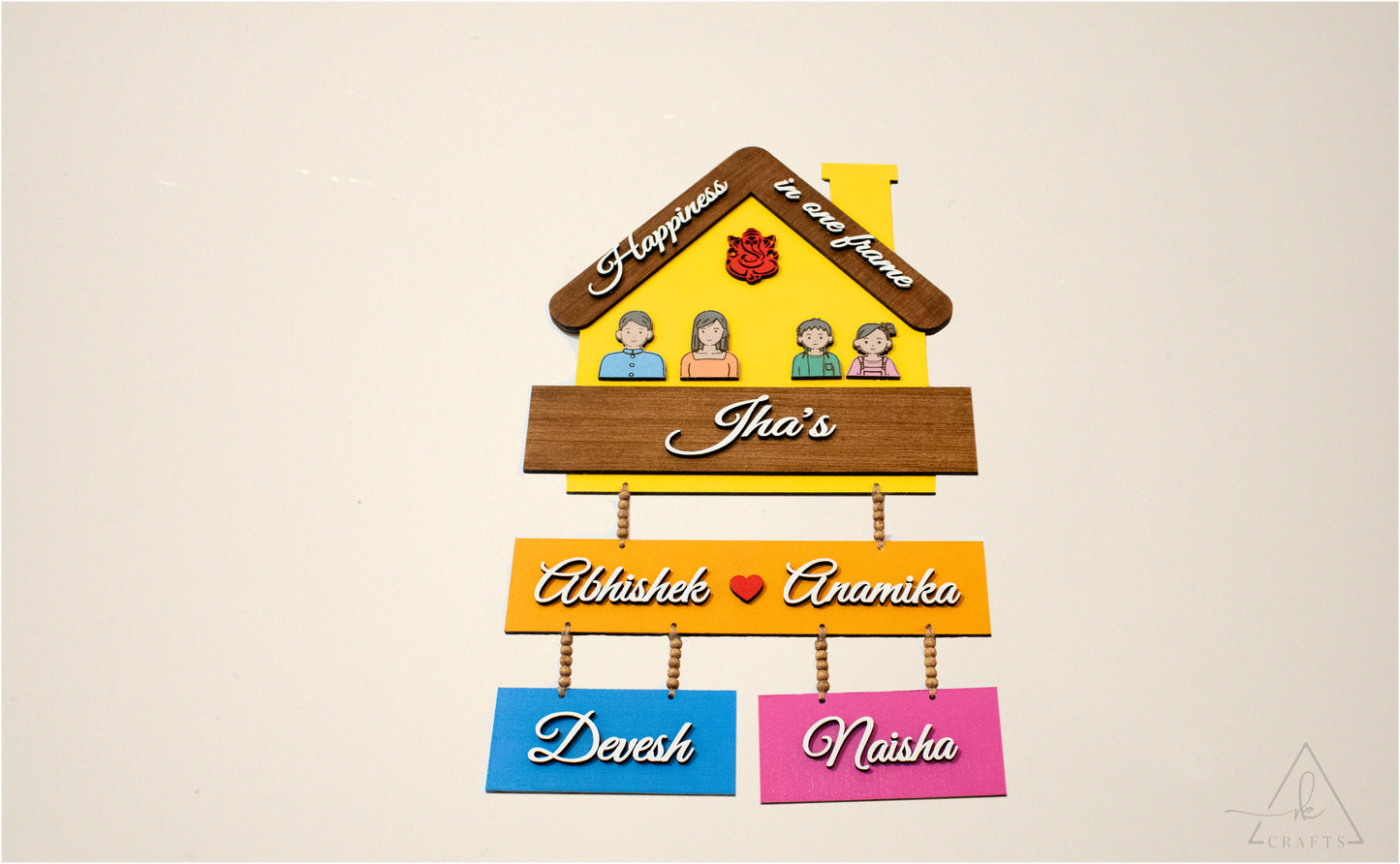 Rustic jute rope and wooden beads on personalized family nameplate.