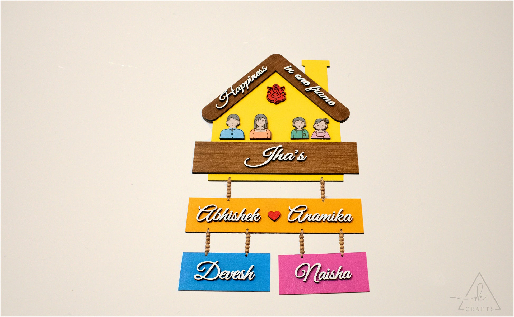Rustic jute rope and wooden beads on personalized family nameplate.